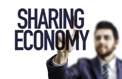 Business man pointing the text: Sharing Economy